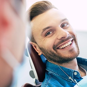 Man smiling at dentist in treatment chair
