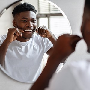 Man smiling while flossing