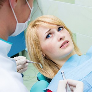 Woman afraid at the dentist.